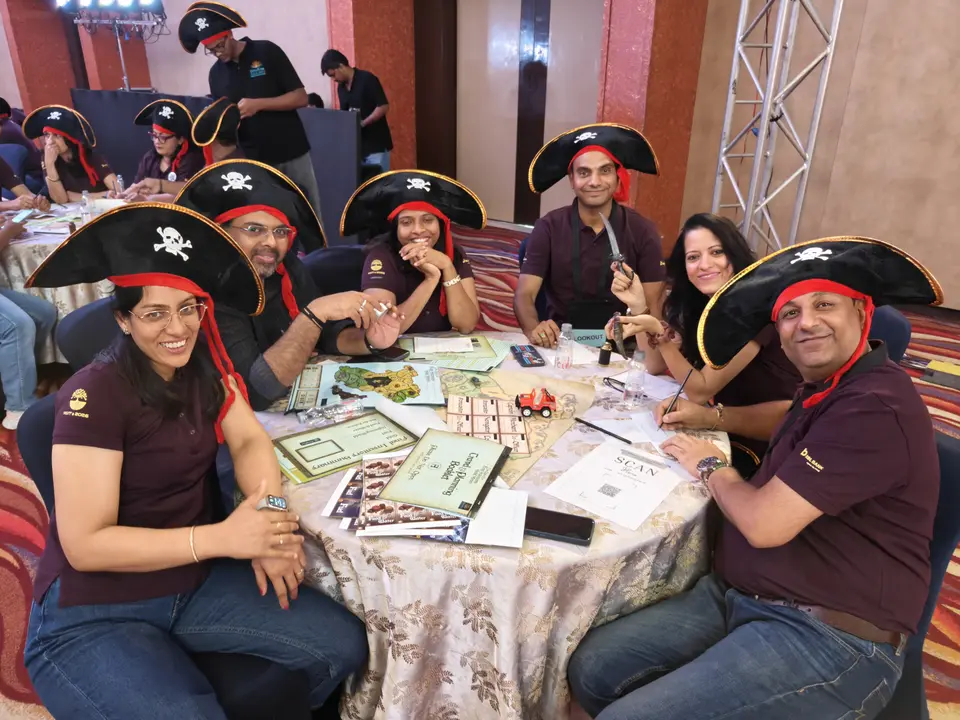 Participants smiling during a SimuRise team building simulation for leadership and collaboration