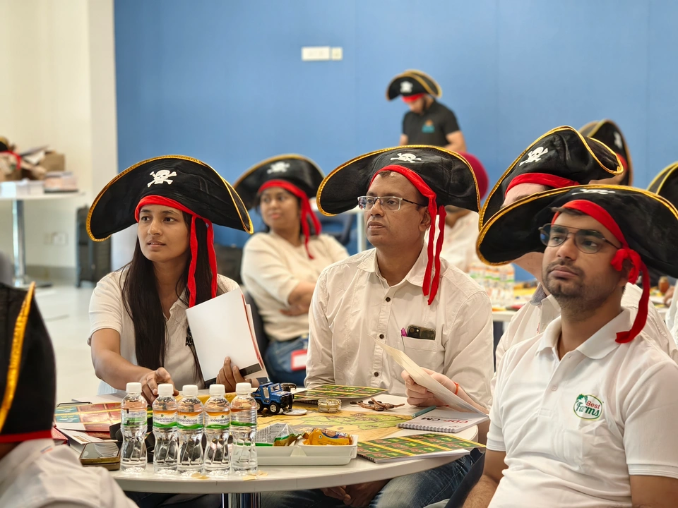 Corporate participants listening during a SimuRise experiential learning session on teamwork and strategy