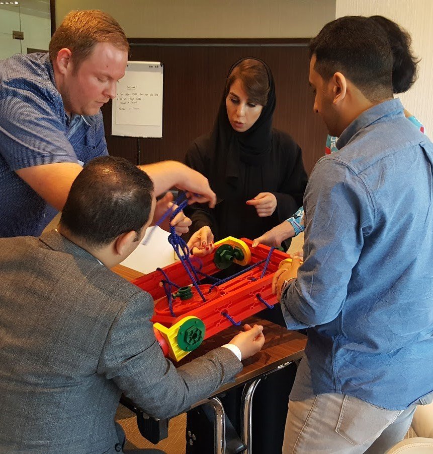 A group of employees leaders and managers playing a Boxed In game prepared by SimuRise used for experiential leadership